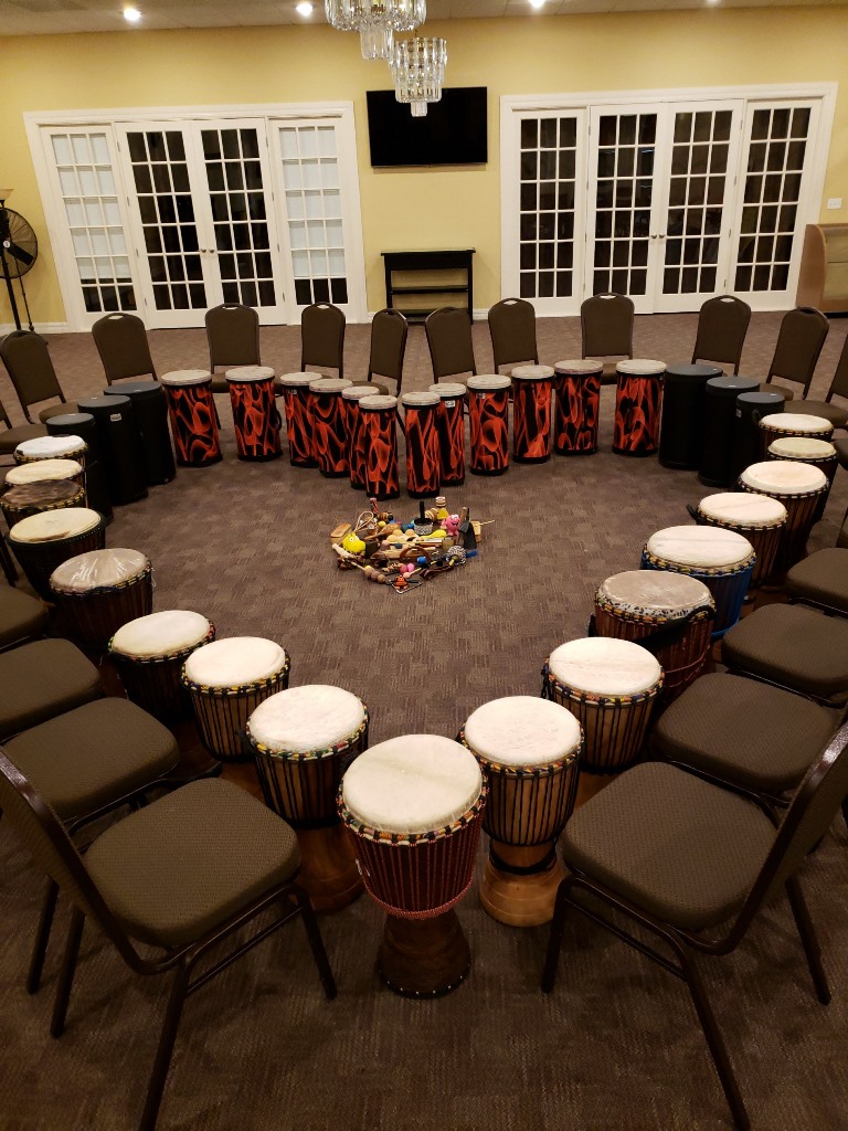 A heart shaped table with many drums around it