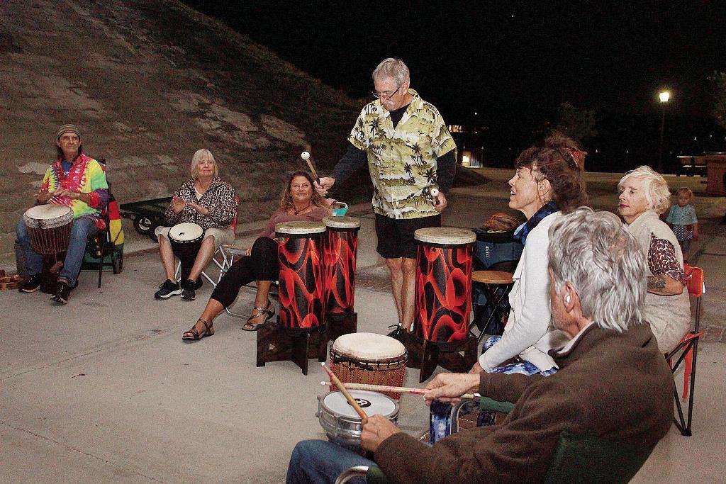 A group of people sitting around playing drums.