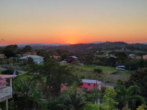 A sunset over the hills of a small town.